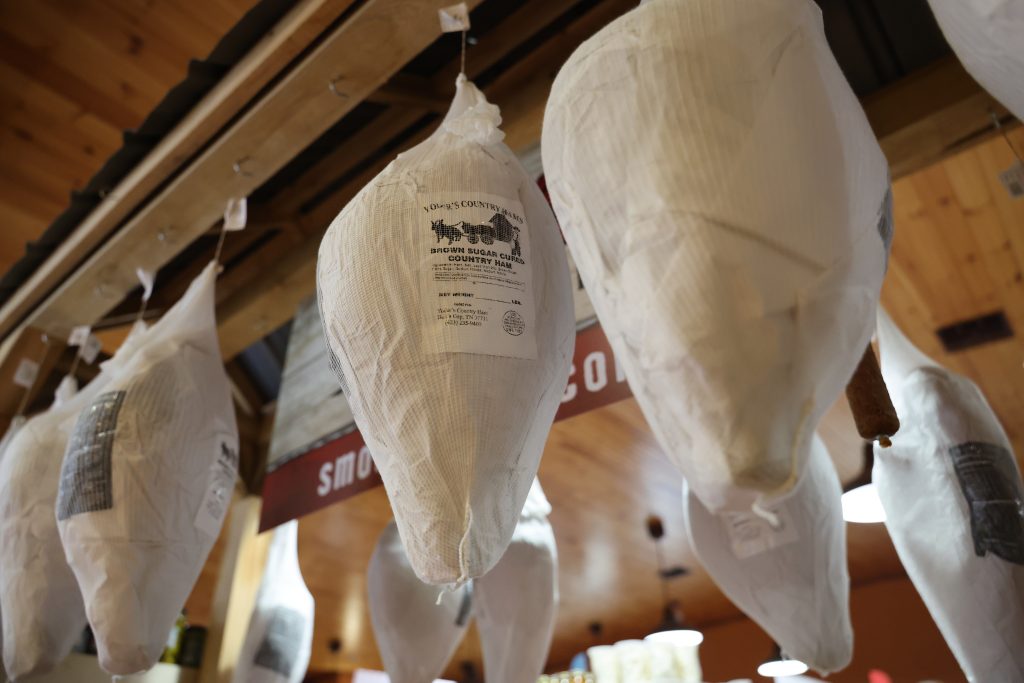 Country Ham hangs from hooks in the Yoder's Country Market store