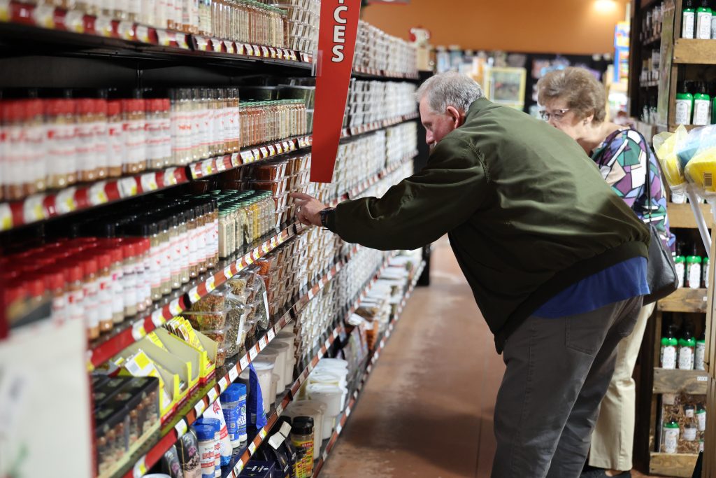 Shoppers browsing grocery store shelves.