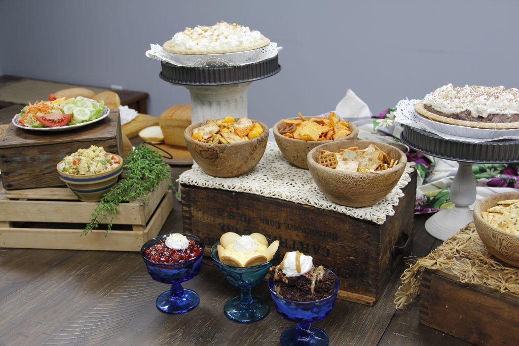 Full display of pies, snacks, salads, and more