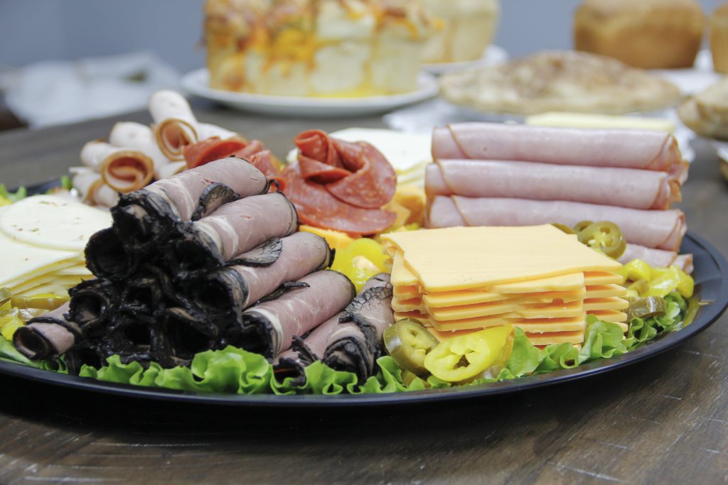 Close-up image of assorted meat and cheese on a tray