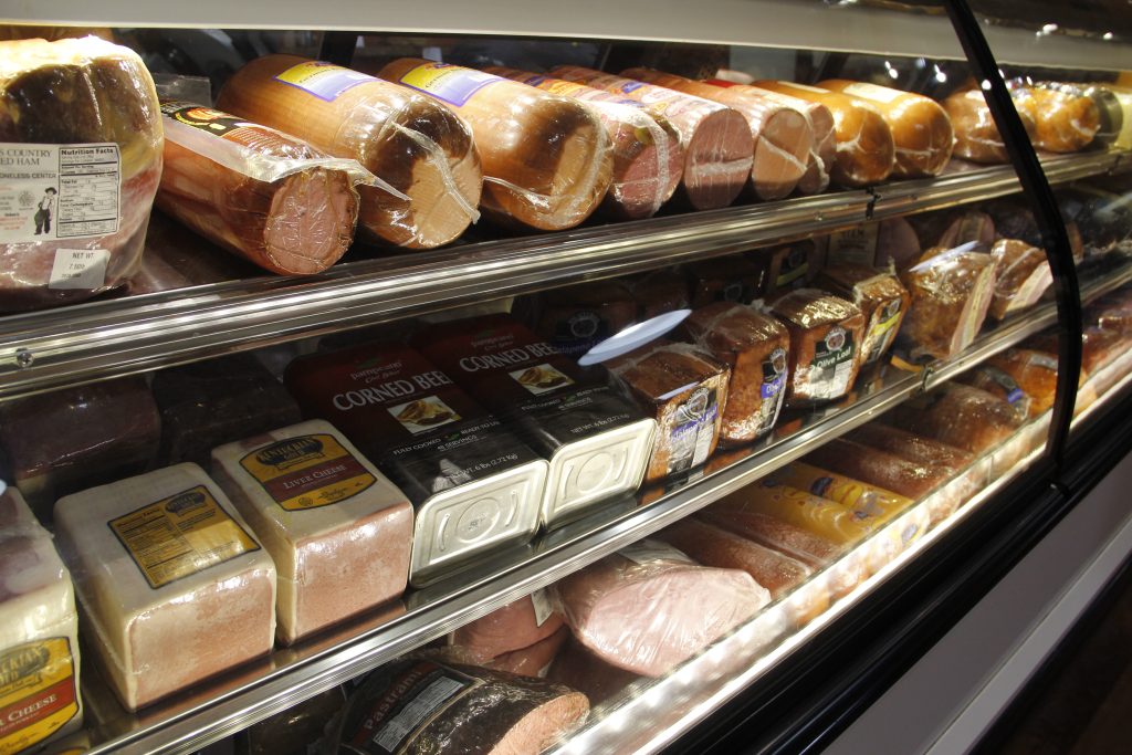 Assorted packaged meats in the deli display case