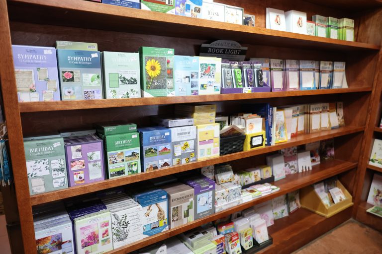 Shelves stocked with birthday cards, get well cards, and other gift items