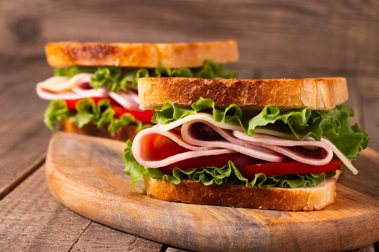 Deli Sandwich resting on a cutting board.